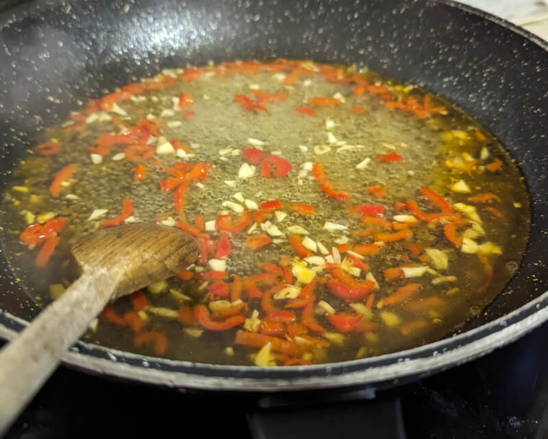 The garlic and chili simmer in white wine.